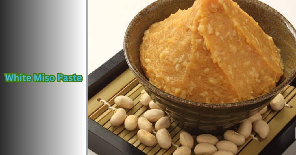 white miso paste in a ceramic bowl with wooden spoon