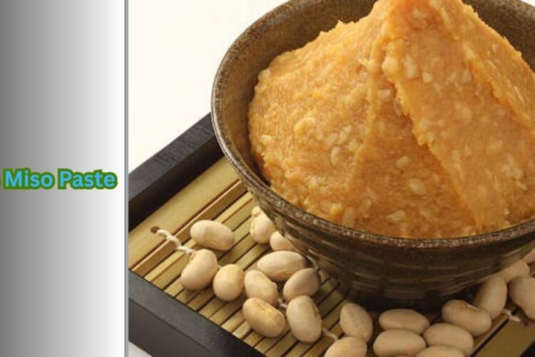 white miso paste in a ceramic bowl with wooden spoon