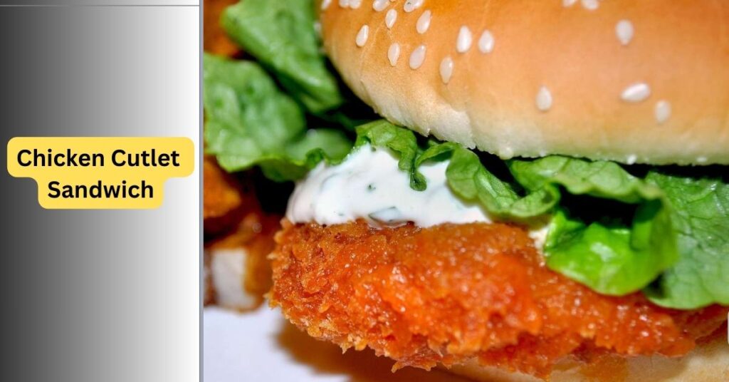 Crispy chicken cutlet sandwich with melted mozzarella, lettuce, tomato, and garlic aioli on toasted bread